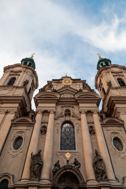 Tiro de ángulo bajo vertical de la Iglesia de San Nicolás bajo el cielo nublado en Praga, República Checa