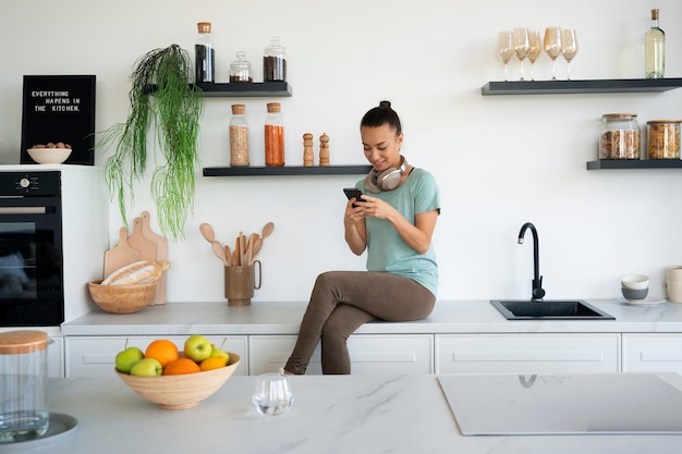 Foto gratuita tiro completo mujer sosteniendo smartphone