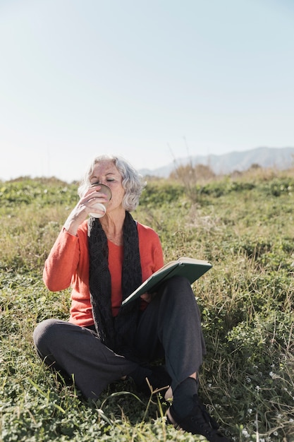 Foto gratuita tiro completo mujer tomando café al aire libre