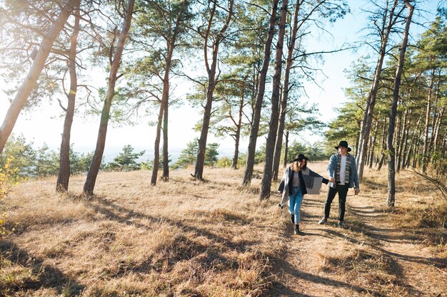 Foto gratuita tiro largo pareja caminando en el parque