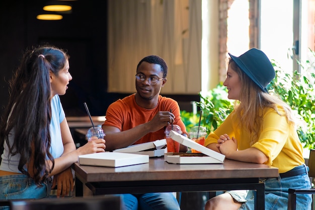 Foto gratuita tiro medio amigos comiendo pizza