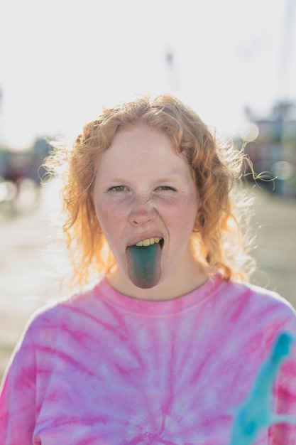 Foto gratuita tiro medio linda chica con lengua azul