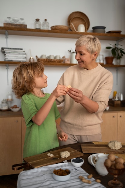 Foto gratuita tiro medio mujer y niño preparando comida