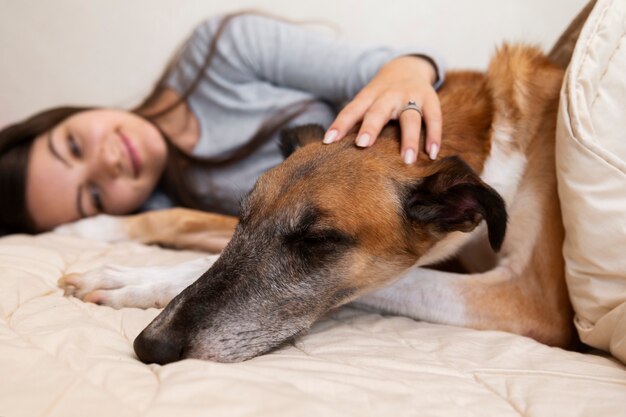 Tiro medio mujer sonriente acariciar a perro