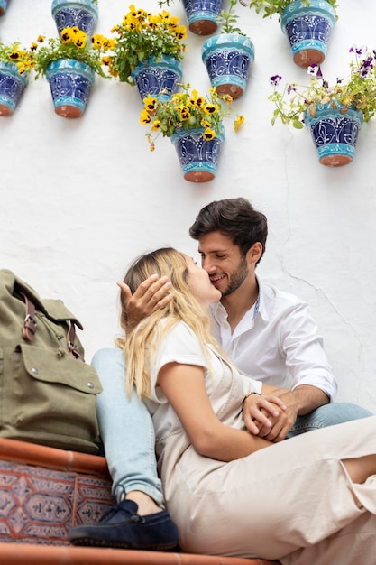 Foto gratuita tiro medio pareja sentada en las escaleras