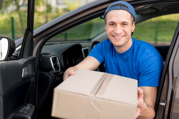 Foto gratuita tiro medio sonriente repartidor en coche