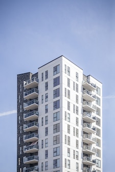 Tiro vertical de un edificio blanco bajo el cielo despejado