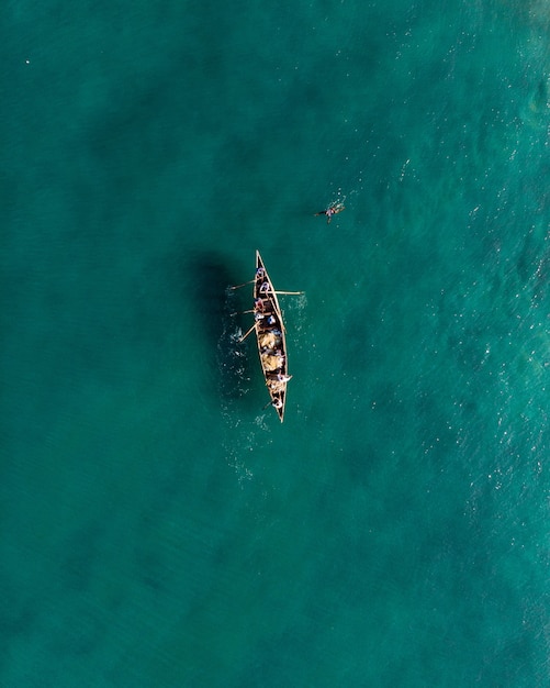 Tiro de vista superior de personas en un barco de pesca en la playa de Varkala