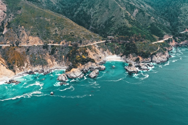 Toma aérea de la hermosa costa rocosa del mar en un día soleado