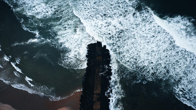 Toma aérea de hermosas olas del mar a la luz del día, perfecta para fondos de pantalla