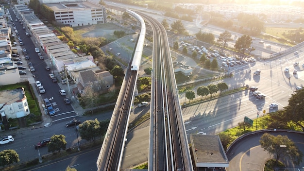 Toma aérea del Tránsito Rápido del Área de la Bahía de San Francisco, el tren se acerca a la estación de Daly City,