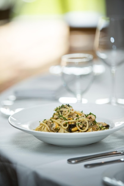 Toma selectiva de una apetitosa pasta con gambas, champiñones y verduras