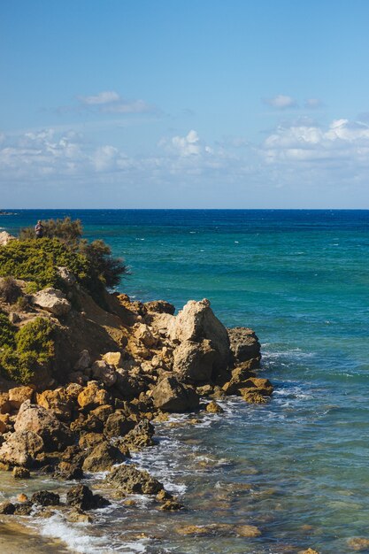 Toma de vista superior de una orilla del mar llena de rocas durante el día