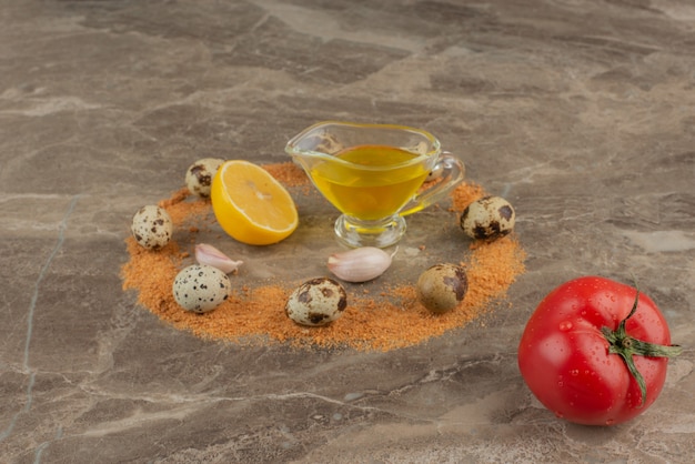 Foto gratuita tomate con aceite, limón y huevo de codorniz.