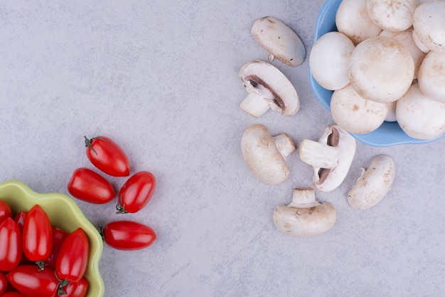 Foto gratuita tomates cherry y setas en gris.