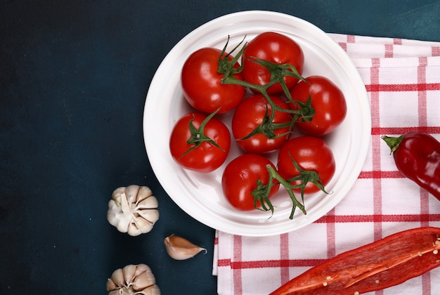 Tomates rojos en un plato blanco.