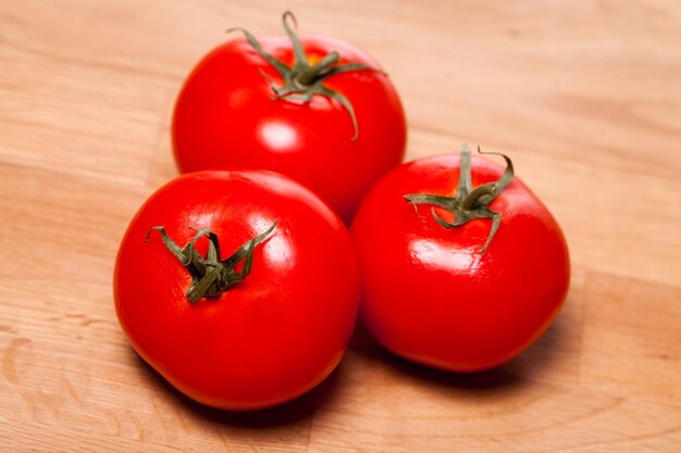 Tomates rojos sobre superficie de madera