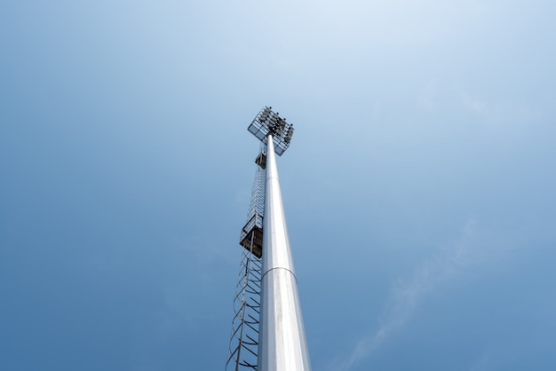 Torre de polo de luz en la arena deportiva en el cielo azul