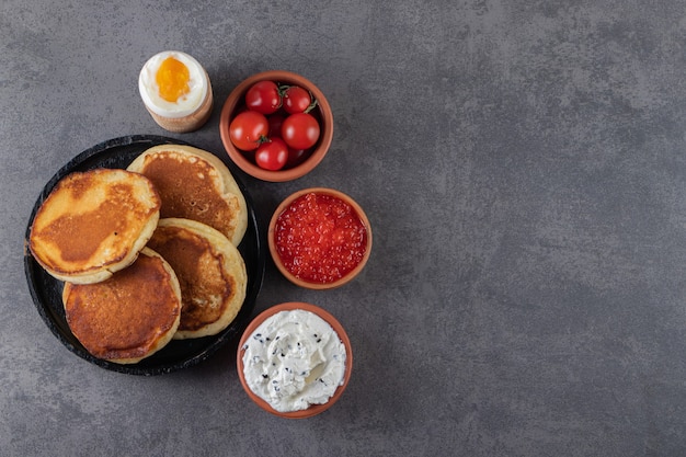 Tortitas dulces con huevo cocido y tomates cherry rojos frescos.