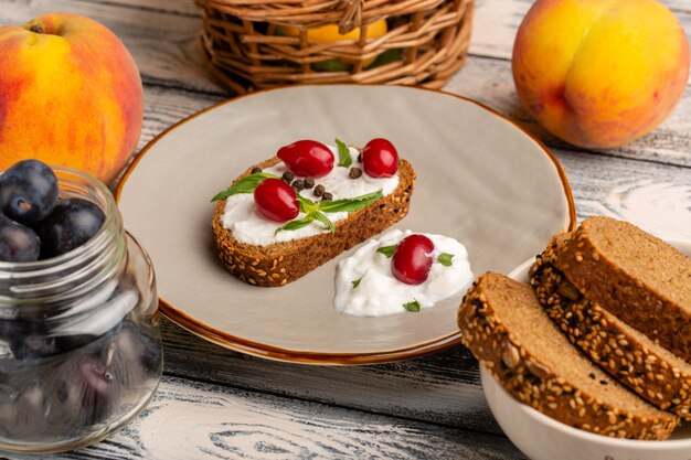 Tostadas de pan con crema agria y cornejo sobre mesa gris pan tostado snack comida comida