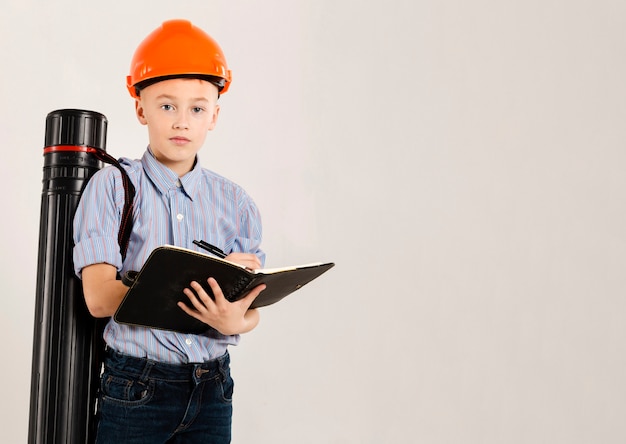 Trabajador de construcción lindo que sostiene el cuaderno