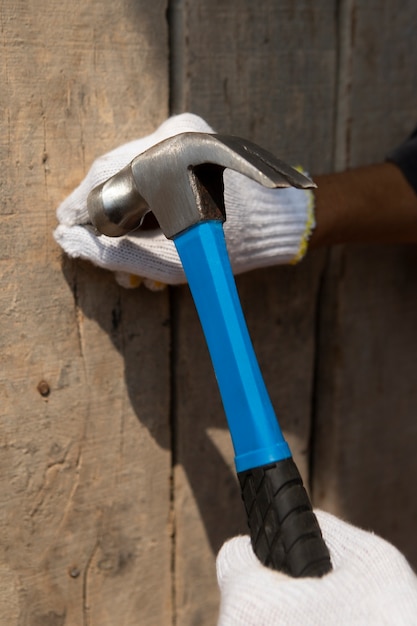 Trabajador de la construcción con martillo en el lugar de trabajo