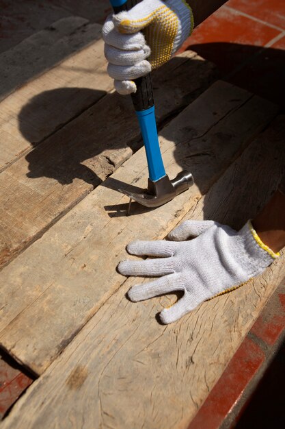 Trabajador de la construcción con martillo en el lugar de trabajo