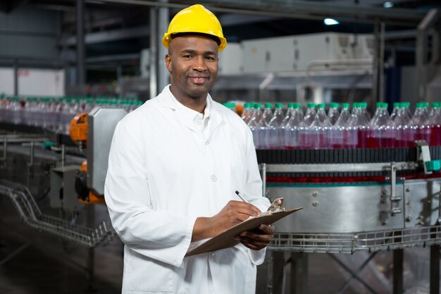 Trabajador sonriente señalando los productos en el almacén