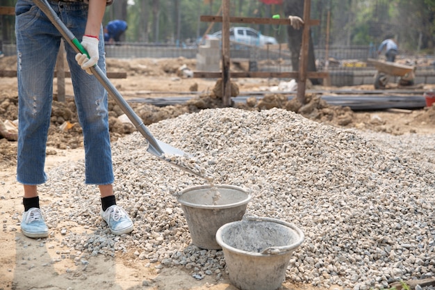 Foto gratuita trabajadores de la construcción llevando una pala al sitio de construcción