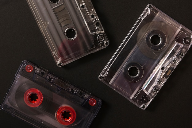 Foto gratuita tres cintas de cassette de audio sobre fondo negro