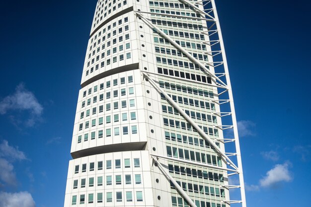 Turning Torso bajo un cielo azul y la luz del sol durante el día en Malmo en Suecia