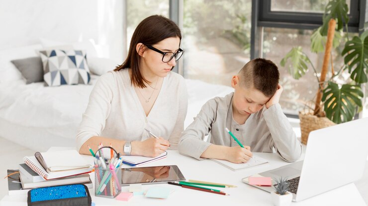 Foto gratuito tutor femenino y chico guapo aprendiendo en casa