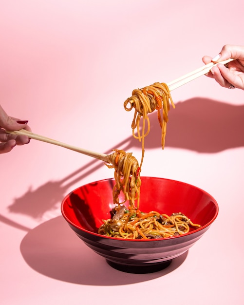 Foto gratuita udon revuelva los fideos fritos con carne, pimiento, cebolla tierna, salsa de soja y sésamo en un tazón