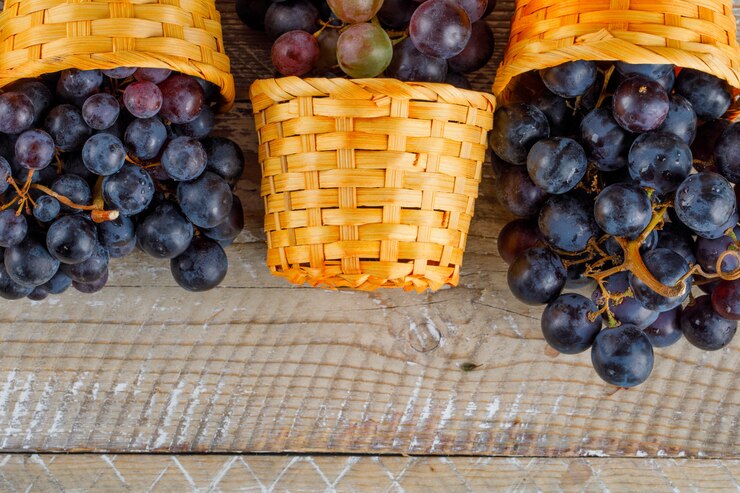 Foto gratuito uvas frescas en cestas de mimbre sobre fondo de madera, primer plano.
