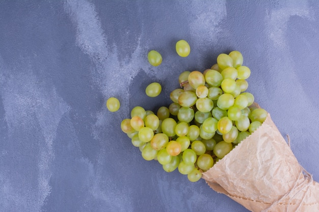 Foto gratuita uvas verdes envueltas en papel.