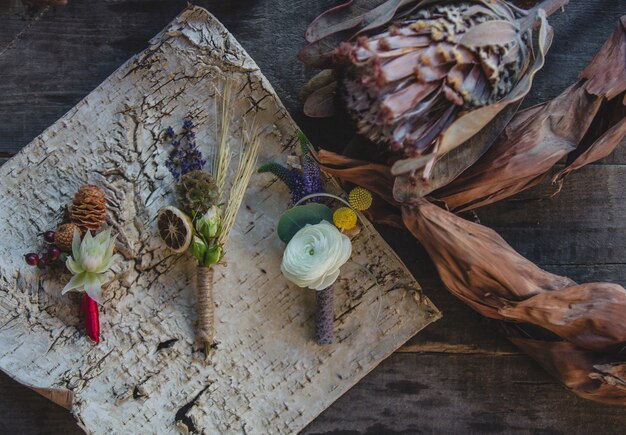 Variedad de alfileres preparados con frutas secas y flores simbólicas de temporada sobre la mesa.