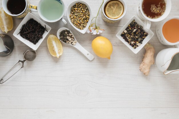 Varios tipos de té con hierbas y hojas secas en mesa de madera