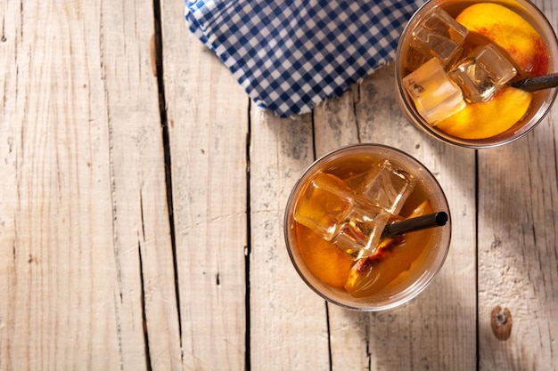 Vaso de té de melocotón con cubitos de hielo