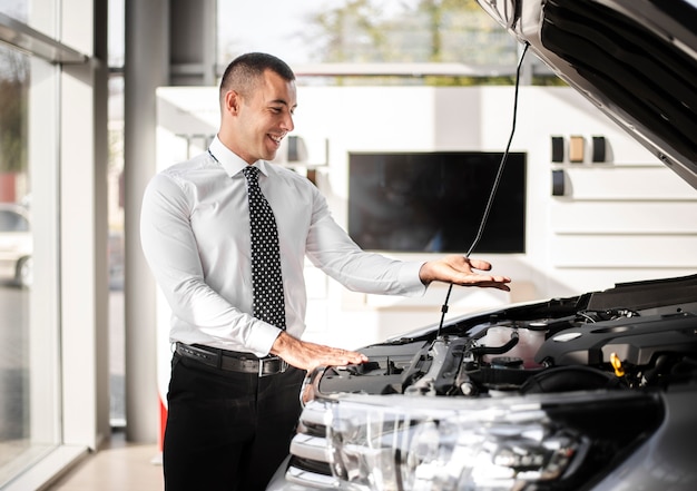 Vendedor de autos revisando un auto