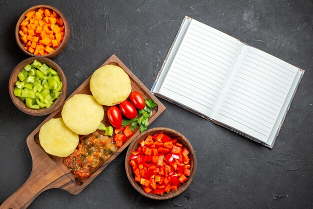 Verduras crudas sobre una tabla de cortar marrón