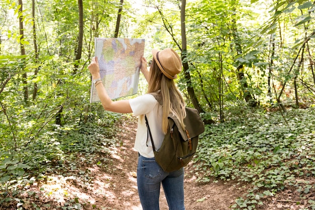 Foto gratuita viajero mirando el mapa desde atrás