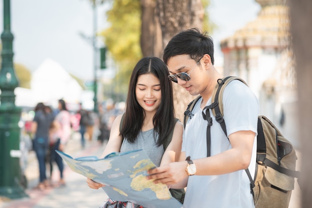 Viajero pareja asiática dirección en mapa de ubicación en Bangkok, Tailandia