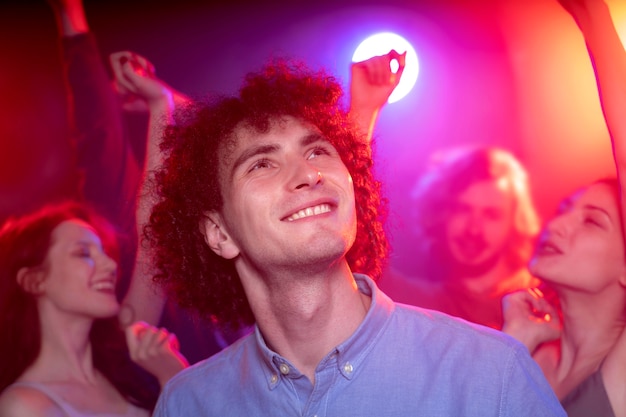 Vida nocturna con gente bailando en un club.