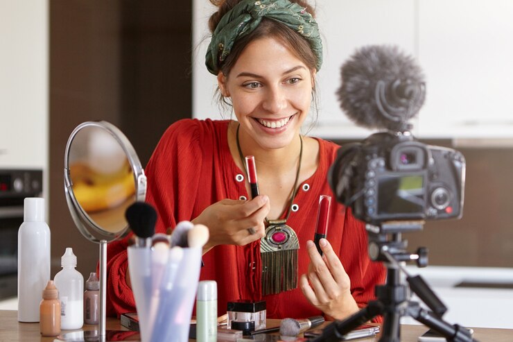 Foto gratuito video de maquillaje de filmación de vlogger femenina