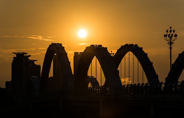 Foto gratuita viejo puente de hierro en la puesta del sol