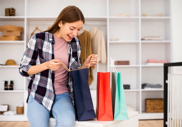 Foto gratuita visión a largo plazo de la mujer que mira en las bolsas de papel