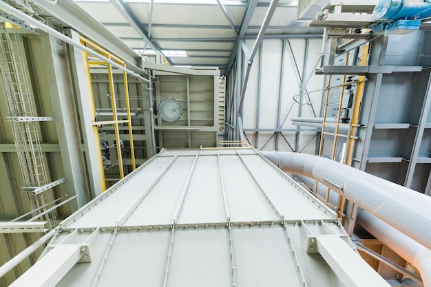 Vista hacia abajo de la planta operativa moderna con tuberías grises y escaleras maquinaria de la industria pesada concepto de taller metalúrgico