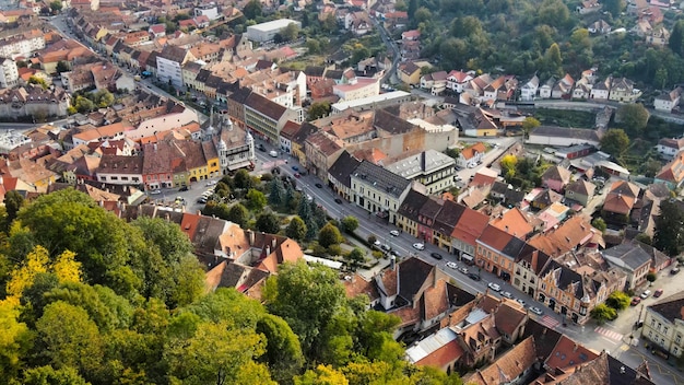 Vista aérea de drones del centro histórico de Sighisoara Rumania Calles de edificios antiguos con coches