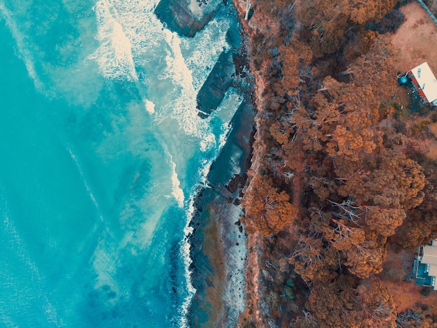 Vista aérea de las olas rompiendo en las rocas