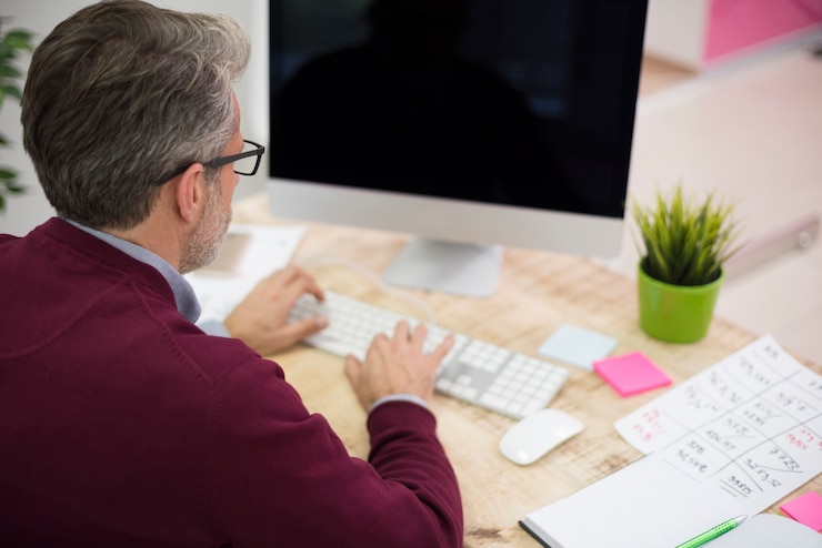 Foto gratuito vista de ángulo alta, de, un, hombre, trabajando, el, computadora
